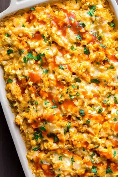 a casserole dish filled with cheese and vegetables