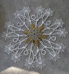 a snowflake made out of scissors on the ground