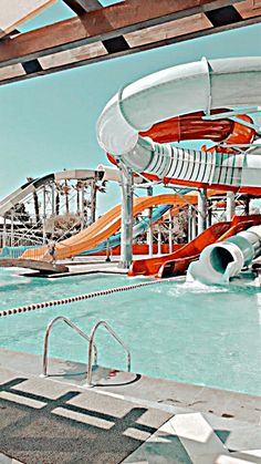 an indoor swimming pool with slides and water park in the backgroung area