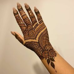 a hand with henna on it that is showing the intricate pattern and design,