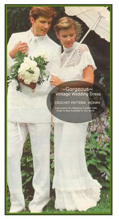 a man and woman standing next to each other under an umbrella in the grass with flowers