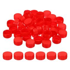 many red plastic caps are stacked on top of each other