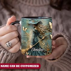 a woman holding a coffee mug with an image on it