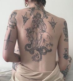 the back of a woman with tattoos on her body