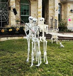 two skeleton statues in front of a house