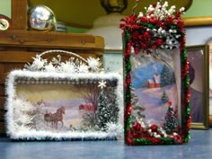 two christmas decorations sitting on top of a table