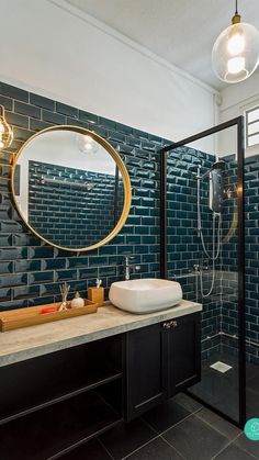 a bathroom with a sink, mirror and shower stall in it's own area