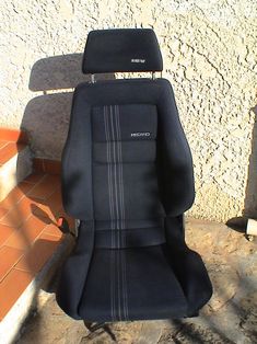 a black seat sitting on top of a tiled floor