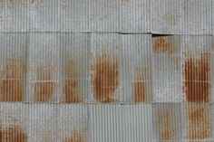 rusted corrugated roof with brown spots on it