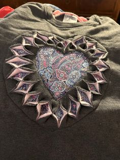 a t - shirt with an intricate heart on it