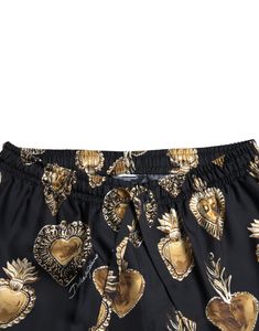 Indulge in the epitome of luxury loungewear with these exquisite Dolce & Gabbana pajama pants. Renowned for their sartorial elegance, these pants are crafted from lush silk, featuring a charming heart print that adds a touch of whimsy to your relaxation time. Designed for ultimate comfort, they boast an elastic waist with a drawstring closure, ensuring a perfect fit. These pants are not just a statement of opulence but also a testament to Italian craftsmanship, making them a must-have in your wa Silk Pajama Pants, It Logo, Haute Couture Brands, Mens Pajama Pants, Luxury Loungewear, Silk Pajama, Loungewear Luxury, Italian Craftsmanship, Dolce E Gabbana