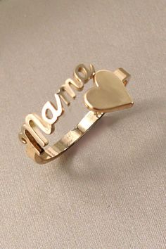 Classic Gold "Mama" Heart Ring, a heartfelt tribute to motherhood and style. This elegant ring features a timeless design with a delicate heart-shaped centerpiece that spells out "Mama" in graceful script. Crafted from high-quality gold, it exudes warmth and sophistication. DIMENSION:Size: 7Metal finish: Gold Platingproduct: Lead & Nickle Compliantanti-tarnish: Double E-coating rings | mama ring | heart ring | gift | mother's day | Adjustable Gold Heart Ring For Mother's Day, Elegant Gold Heart Ring For Mother's Day, Personalized Adjustable Heart Ring For Mother's Day, Gold Heart Ring For Wedding And Mother's Day, Elegant Personalized Heart Ring For Mother's Day, Elegant Hallmarked Rings For Mother's Day, Gold Heart Ring For Mother's Day Promise, Gold Heart Ring For Mother's Day, Gold Heart Promise Ring For Mother's Day