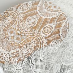 the white lace is on top of an old doily