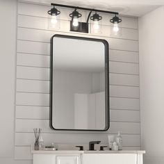 a bathroom with a sink, mirror and lights