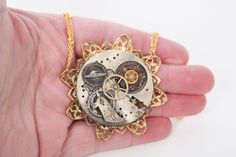 Steampunk necklace made from a real watch movement. - I had this old watch that didn't work anymore and took out this movement. - I paired it with an amazing filigree piece that is gold tone in color. - I paired it with a vintage button that is placed on the watch movement. - The main piece is strung on a gold toned chain that is doubled up to add to the design. - The whole necklace is 18 inches from end to end. - The main piece is 2 inches in diameter. ----------------------- You looking for that perfect addition to a steampunk wardrobe?  Aren't too sure what it is, but you know its missing something?  Well, this amazing necklace is perfect for that.  It is made from a real watch movement taken out of an old pocket watch.  The movement is mounted on top of a beautiful gold toned filigree Ren Fair Costume, Steam Punk Wedding, Punk Wedding, Old Pocket Watches, Old Watch, Ren Fair, Victorian Pendants, Steampunk Wedding, Steampunk Cosplay