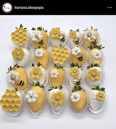 a bunch of strawberries with flowers and bees on them are arranged in the shape of hearts