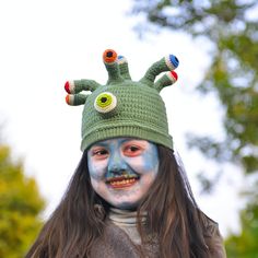 Whimsical Halloween Party Hat with Colorful Antennae 👻🎉 Elevate your Halloween attire with our charming party hat! This green hat features a flurry of playful antennae, each adorned with a different colored eyeball for a dash of whimsy. Perfect for Halloween celebrations, you'll be the star of the show! Key Features: Festive Design: Get into the Halloween spirit with this vibrant green hat and its eye-catching eyeball antennae. Customizable Fit: The hat has a circumference of approximately 20.5 inches. If it doesn't quite fit, don't worry - just contact us for a custom size. Durable and Easy to Clean: Made to withstand the festivities and easy to clean if it gets a little spooky. Ideal Gift: This hat makes for a fantastic holiday gift and is a must-have for Halloween. Transform your Hall Fun Costume Hats And Headpieces, Fun Costume Hats And Headpieces For Party, Fun Hats For Carnival Costume, Fun Carnival Costume Hat, Halloween Cosplay Beanie Hat, Fun Carnival Costume Hats And Headpieces, Green Novelty Party Hat, Playful Carnival Costume Accessories, Adjustable Green Novelty Costume Hat