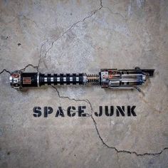 a space junk rocket sitting on top of a cement floor next to the words space junk