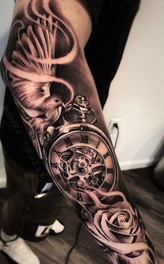 a man's arm with a clock and roses on it