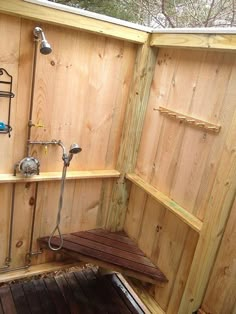 an outdoor shower with wooden walls and wood flooring