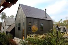 a house with a metal roof and wooden steps