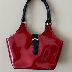 Beautiful Red/Black Hand Bag Never Used Buckle Is Actually A Magnetic Closure Top Zipper Closure Inside Has A Large Central Zipper Closure And A Smaller Zipper Pocket And One Small Slip Pocket Exterior Zippered Pocket On Back Of Bag Measures Approximately 10”L X6”H X4”D Dust Bag Included Red Satchel Shoulder Bag With Snap Closure, Chic Red Bag With Snap Closure, Red Formal Bag With Hasp Closure, Red Shopping Bag With Snap Closure, Red Bags With Snap Closure For Shopping, Trendy Red Shoulder Bag With Hasp Closure, Everyday Red Shoulder Bag With Snap Closure, Red Shoulder Bag With Snap Closure For Everyday, Casual Red Evening Bag