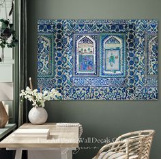 a blue and white wall hanging over a desk with a vase on top of it