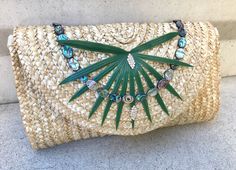 Handmade Palm Abalone Shell Clutch, Beach Bag, Palm Leaf Bag, Boho Bag, Festival Tote, Shell Trim, Tropical Bag, Bridal, Tropical Wedding Emotion behind the making:  Like my jewelry, I wanted to create a certain feeling. In this case, it was the combo of a faux Palm leaf, beaded Abalone Shells, and rhinestone accents that captured the essance of summer and allowed me to show what I was feeling in the form of this exotic purse. Construction: Each flower, branch, leaf or shell is carefully wrapped with wire or glued securely. All trim is then glued onto the bag. I carefully eye each location of the flower and tie/glue in place for a well balanced, symmetrical look. The bag is carefully wrapped and packaged for shipping and handing.  Where to use it!: This bag adds the perfect touch to any bi Traditional Handmade Beach Clutch, Beaded Beach Clutch Bag, Bohemian Handmade Clutch In Natural Color, Bohemian Handmade Clutch For Vacation, Beaded Rectangular Beach Clutch, Palm Leaf Bag, Tropical Bag, Shell Clutch, Leaf Bag