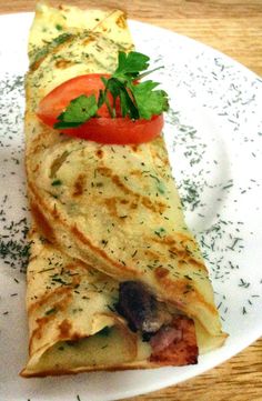 a white plate topped with two quesadillas on top of a wooden table