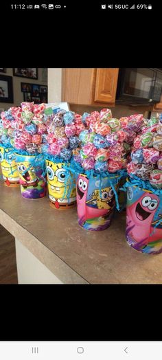 several buckets filled with candy sitting on top of a counter