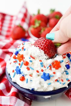 a person is decorating a cake with red, white and blue sprinkles