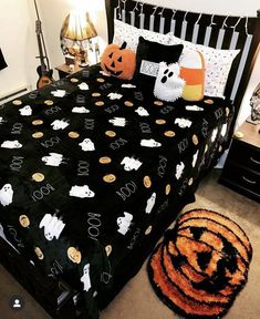 a bed with halloween decorations on it in a bedroom