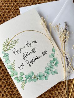 two wedding cards on top of each other next to some flowers and an envelope with the words mr and mrs always married