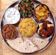 a metal plate topped with different types of food