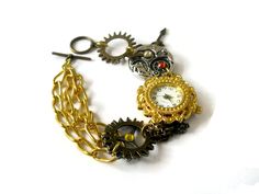 This beautiful steampunk watch bracelet is a unique art piece for the purveyor of eclectic and  sophisticated hand-crafted artisan jewelry. Steampunk is a unique style that combines the  Victorian look with a cog and steam powered industrial revolution look. The effect is certainly  unique and eye-catching.  Gears, cogs, watch parts and Swarovski crystals make this chunky bracelet a wondrous thing.  Surrealism meets realism in this esoteric world of tech. Steampunk jewelry is an impressive  phen Fantasy Bracelet, Schmuck Gold, Steampunk Watch, Watch Jewelry, Chunky Bracelet, Swarovski Crystal Jewelry, Crystal Jewellery, Chunky Bracelets, Jewellery Gold