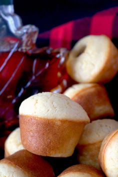 a pile of muffins sitting on top of a table next to a jar of jelly