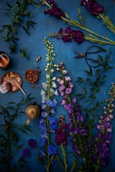 purple flowers and tea cups on a blue surface