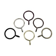 four different colored metal rings on a white background