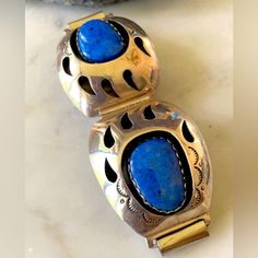 Beautiful Navajo Denim Lapis Bear Paw Watch Tips. Fabulous Denim Blue Lapis, Handcrafted By Known Artist Teddy Goodluck In His Signature Shadowbox Technique, Stone Set On An Oxidized Layer To Create The Shadowbox Look. Give Your Watch A New Look. Will Look Great With Your Native Southwestern Jewelry. Men’s Or Women’s. Listing Is For The Denim Lapis Watch Tip Only. Size Of Watch Tips Is 1 1/4��” X 1 3/4” 26 Grams Weight Of Tips Only. Watch Connection Is Approximately 3/4” Stamped Sterling Hallmark Bear Paw, Jewelry Men, American Denim, Southwestern Jewelry, Bear Paws, Blue Lapis, Four Leaf Clover, Stone Settings, Denim Blue