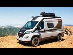 an rv parked on the side of a mountain