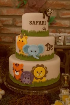 a three tiered cake with animals on it