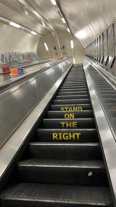 an escalator with the words stand on the right written on it in yellow