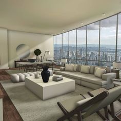 a living room filled with lots of furniture and large windows overlooking the cityscape