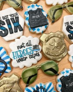 decorated cookies are arranged on a table with sunglasses and other items in the shape of police badges