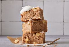 three pieces of cake stacked on top of each other in front of a white tile wall