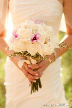 a bride holding a bouquet of flowers in her hands