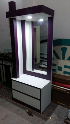 a purple and white dressing table with mirror