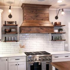 a stove top oven sitting inside of a kitchen next to wooden shelves and open shelving