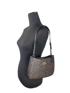 Style: Coach Penelope Shoulder Bag (Brown/Black) Material: Leather/PVC Features: Snap Closure, Fabric Lined, Signature Coach Design Measures: 10" L x 7" H x 1" D Shoulder Bag Brown, Style Coach, 7 H, Snap Closure, Leather Shoulder Bag, Shoulder Bag, Leather, Fabric, Black