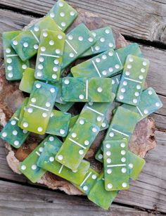 green and white dices sitting on top of a piece of wood